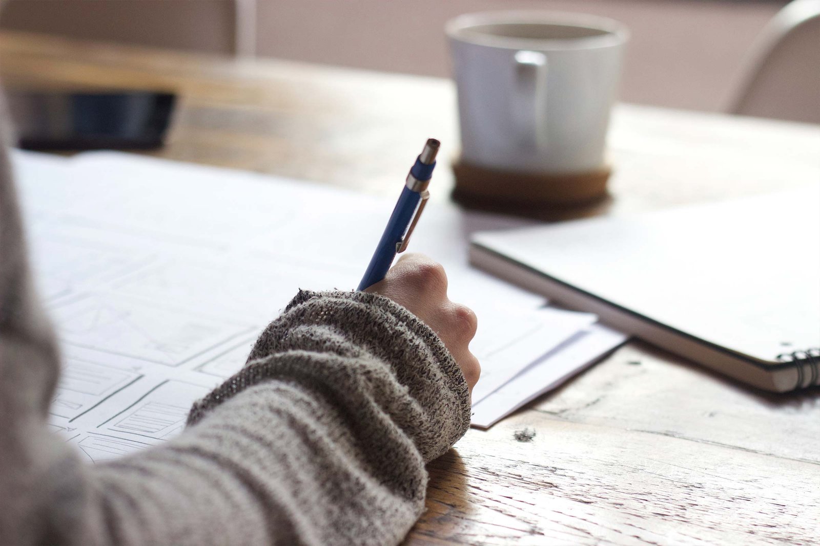 Person Writing at a Desk