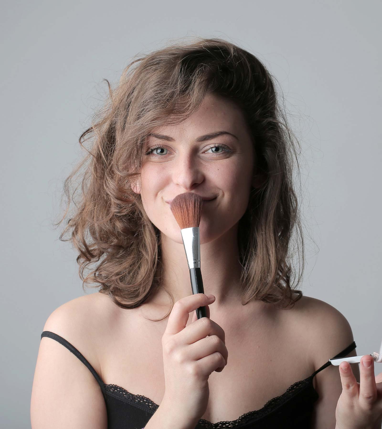 Woman holding Makeup Brush